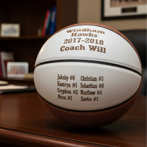 Full size basketball engraved with a team name, the season and the coach name above the full player roster, given as an end of season basketball coach gift.