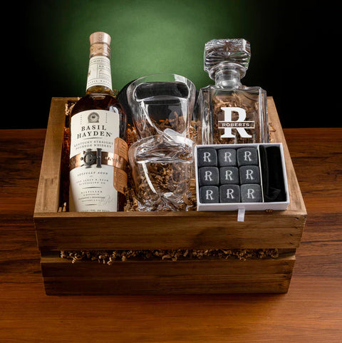 Personalized whiskey gift set with an engraved decanter, cigar-holder glasses, whiskey stones, and slate coasters in a wooden box, a thoughtful gift for a 55 year old man.