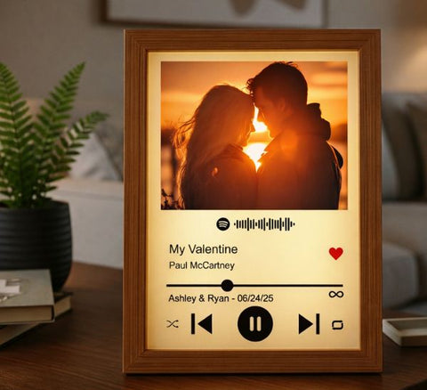 Personalized wooden frame night light showing a couple silhouetted at sunset above a music player panel engraved My Valentine with the couple's names and date.