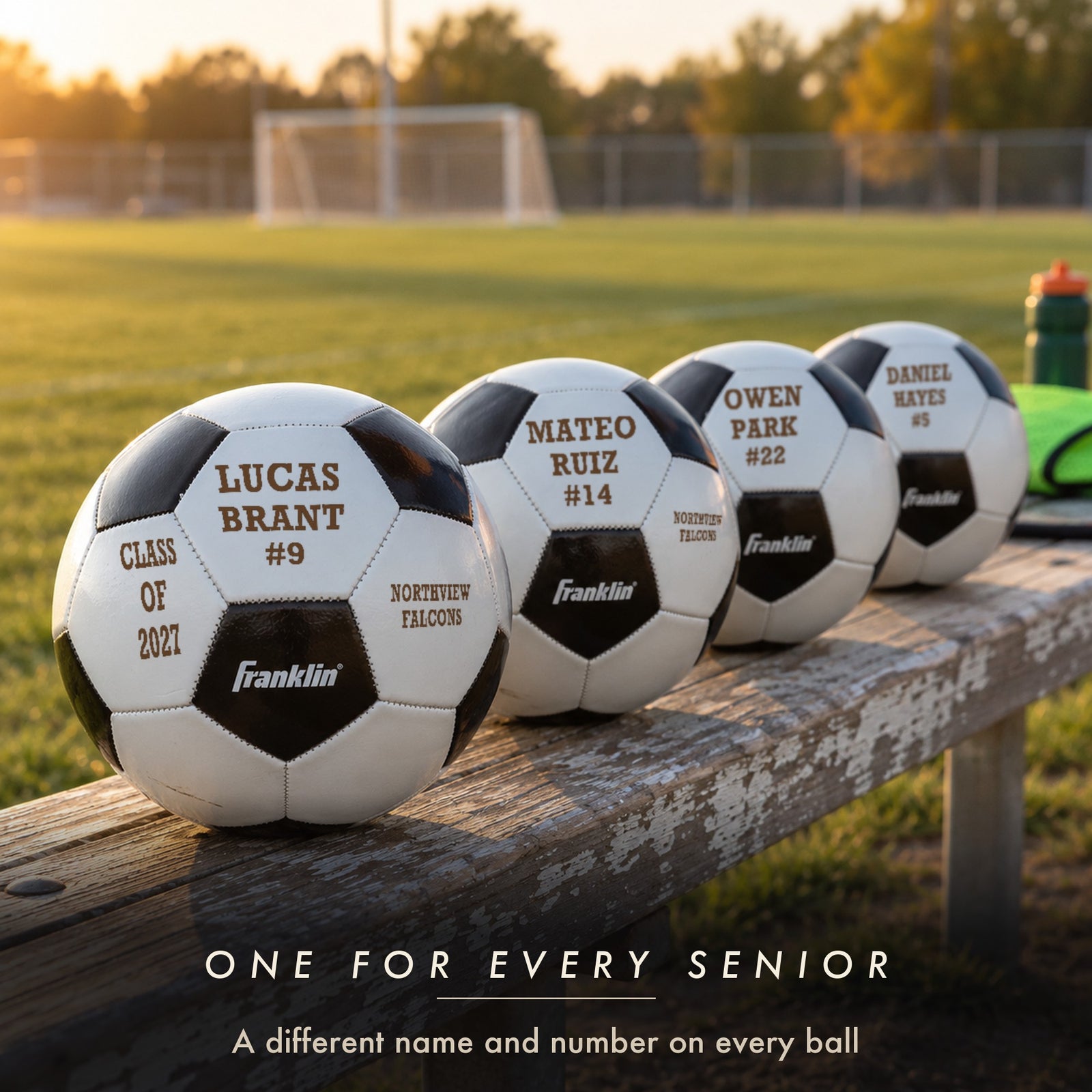 Four engraved soccer balls on a team bench, each with a different player name and number and the same class and team, senior gifts for soccer players