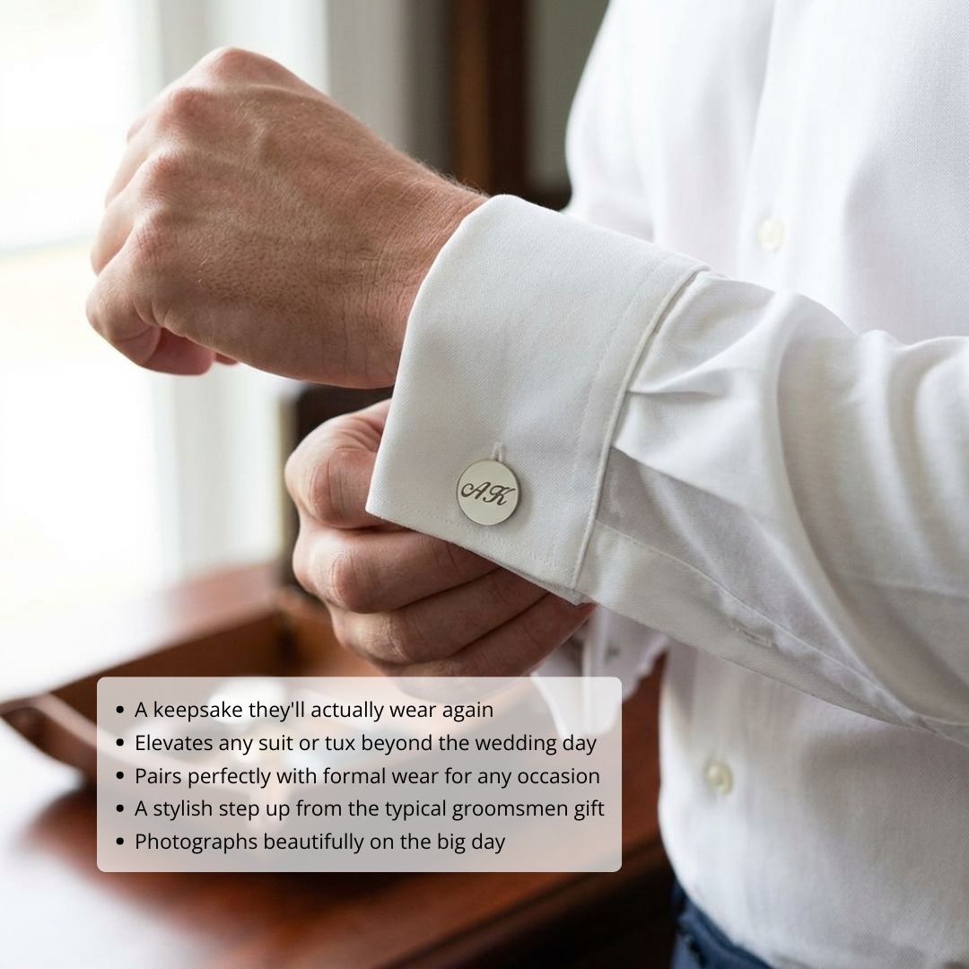 Man wearing white dress shirt with round silver cufflinks engraved with sample monogram, displayed on wrist during formal occasion