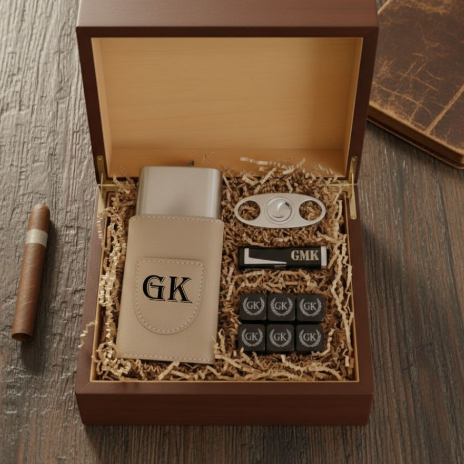 Personalized cigar gift set in an open wood box: a tan travel case engraved GK, a cigar cutter, a lighter engraved GMK and whiskey stones engraved GK