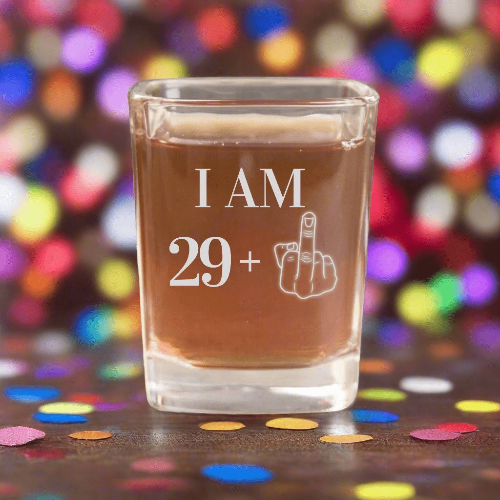 The original 30th birthday shot glass photo: I AM 29 plus a middle finger engraved on a square glass, a funny gift for the big birthday party