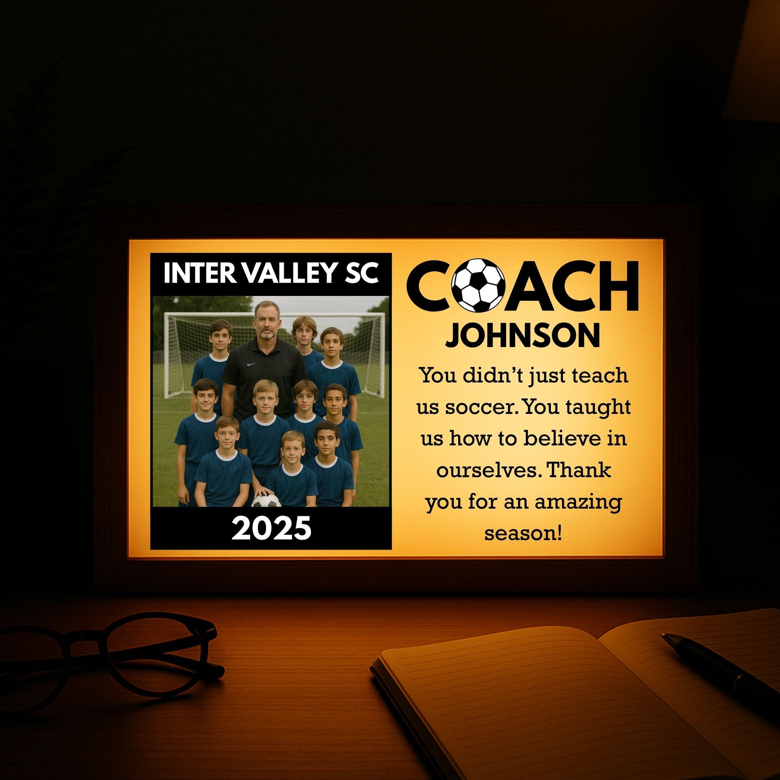 Illuminated wood-framed light box displaying team photo, "Inter Valley SC Coach Johnson" text, 2025 season year, and thank-you message to coach on warm yellow background