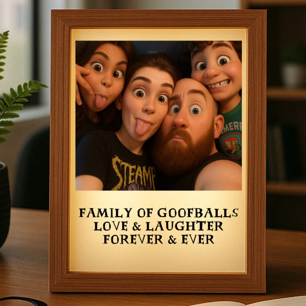 Wooden frame with cream mat displaying sample cartoon-style photo of family with personalized text "Family of Goofballs Love & Laughter Forever & Ever" below image, LED-backlit acrylic display