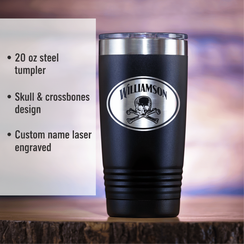 Black 20 oz steel tumbler with stainless steel rim, featuring laser-engraved sample name "Williamson" above skull and crossbones design in oval badge