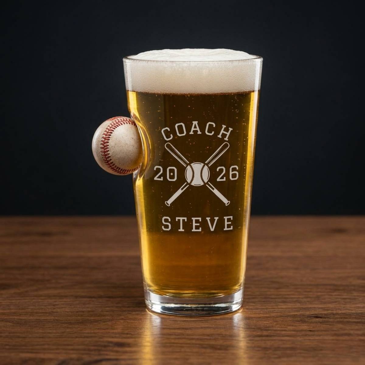 Personalized baseball coach gift pint glass engraved with crossed bats, the word COACH, the coach's name and year, and the team's full player roster on the back.