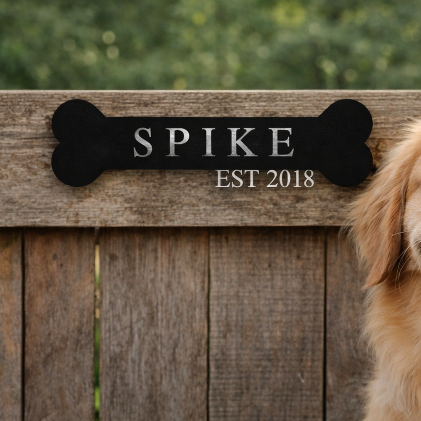 Dog named Spike sitting in front of a wooden bench with a plaque behind it.