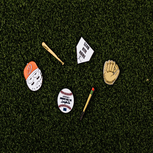 Home plate-shaped golf ball marker with “Send Him Home” text and magnetic backing for easy attachment.