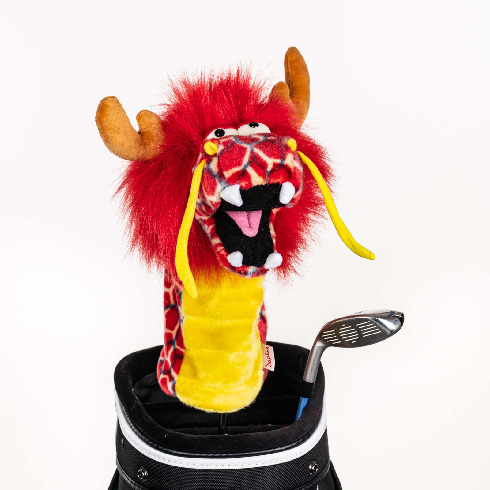 Plush red dragon golf headcover covering a club in a golf bag, a standout golf gift for men from Groovy Guy Gifts