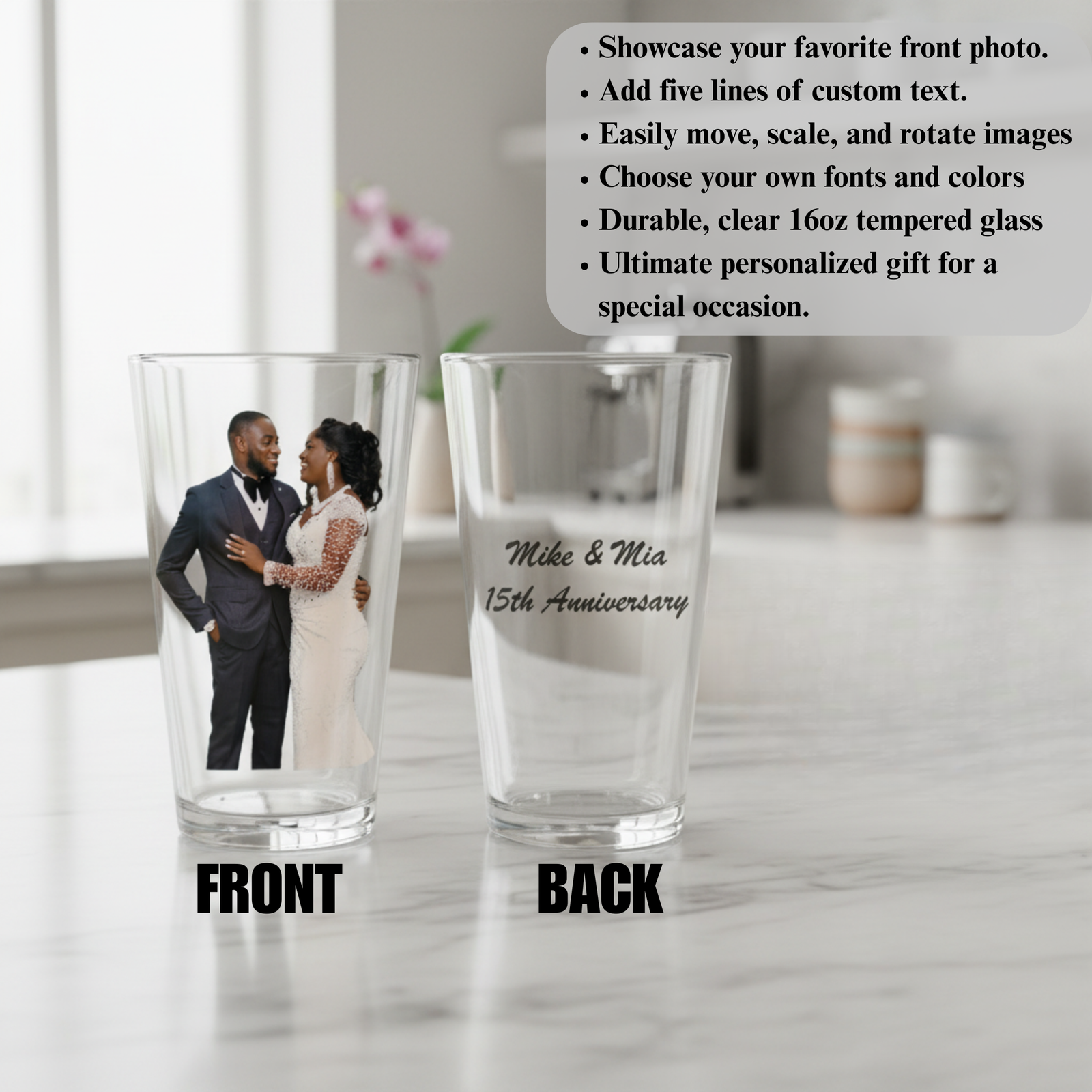 Two clear 16oz pint glasses displayed front and back; front glass shows sample photo of couple in formal wedding attire, back glass features sample engraving reading "Mike & Mia 15th Anniversary