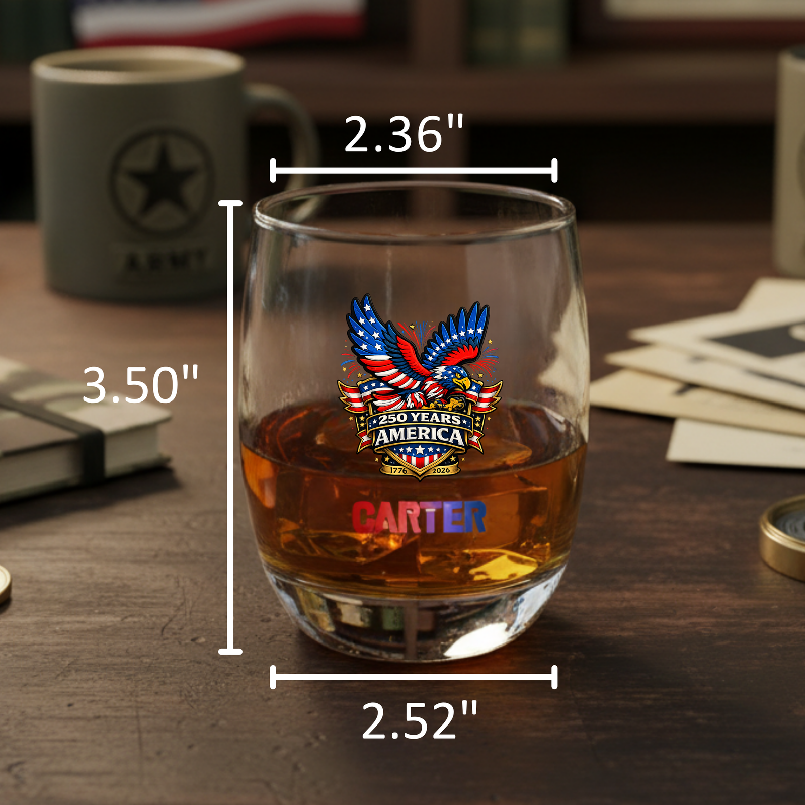 Engraved whiskey glass with eagle and "250 Years America" design, sample name "Carter" in red, filled with whiskey, dimensions marked at 3.50" height and 2.36" width.