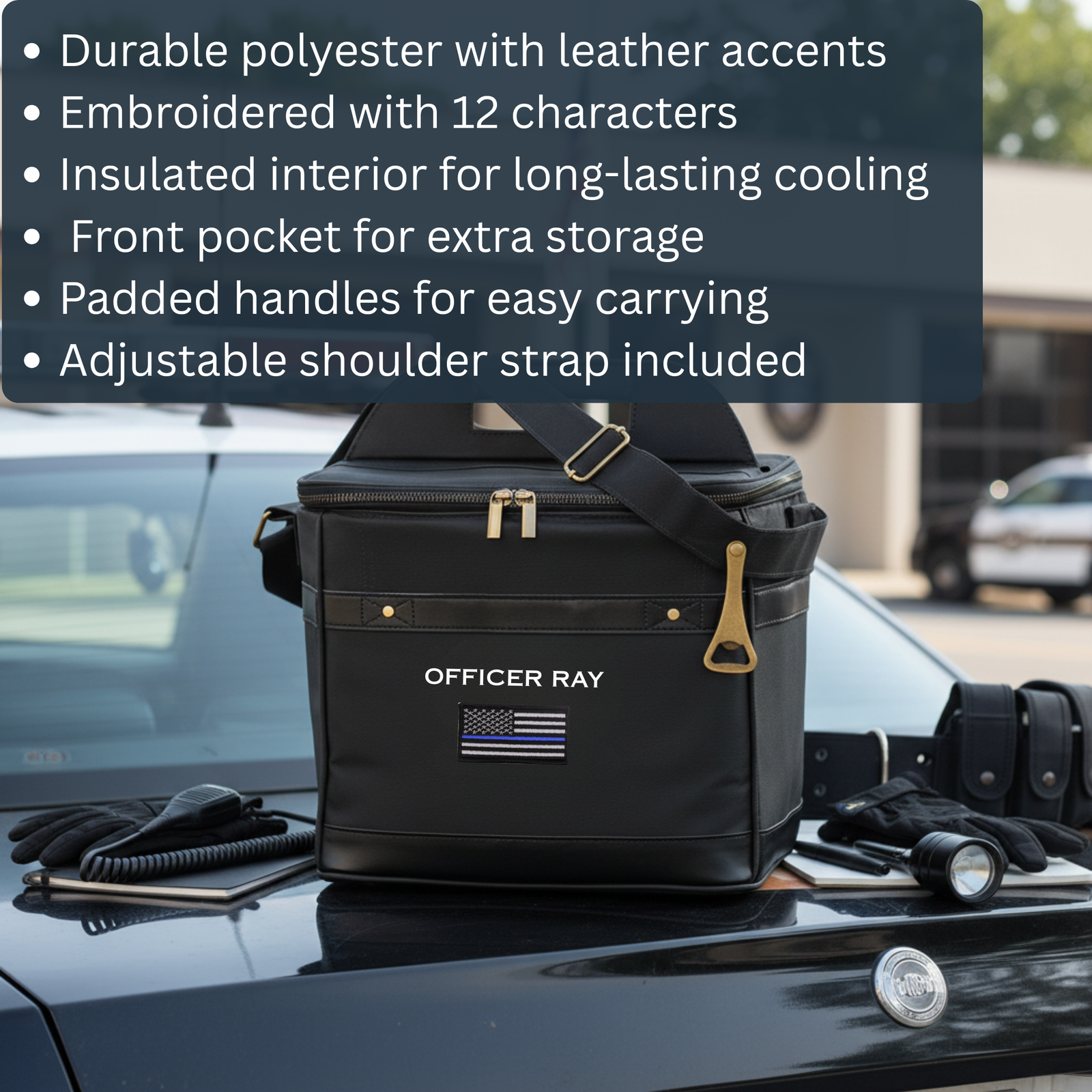 Black insulated cooler with embroidered sample text "OFFICER RAY" and thin blue line flag patch, displayed on vehicle hood with shoulder strap and leather accents.