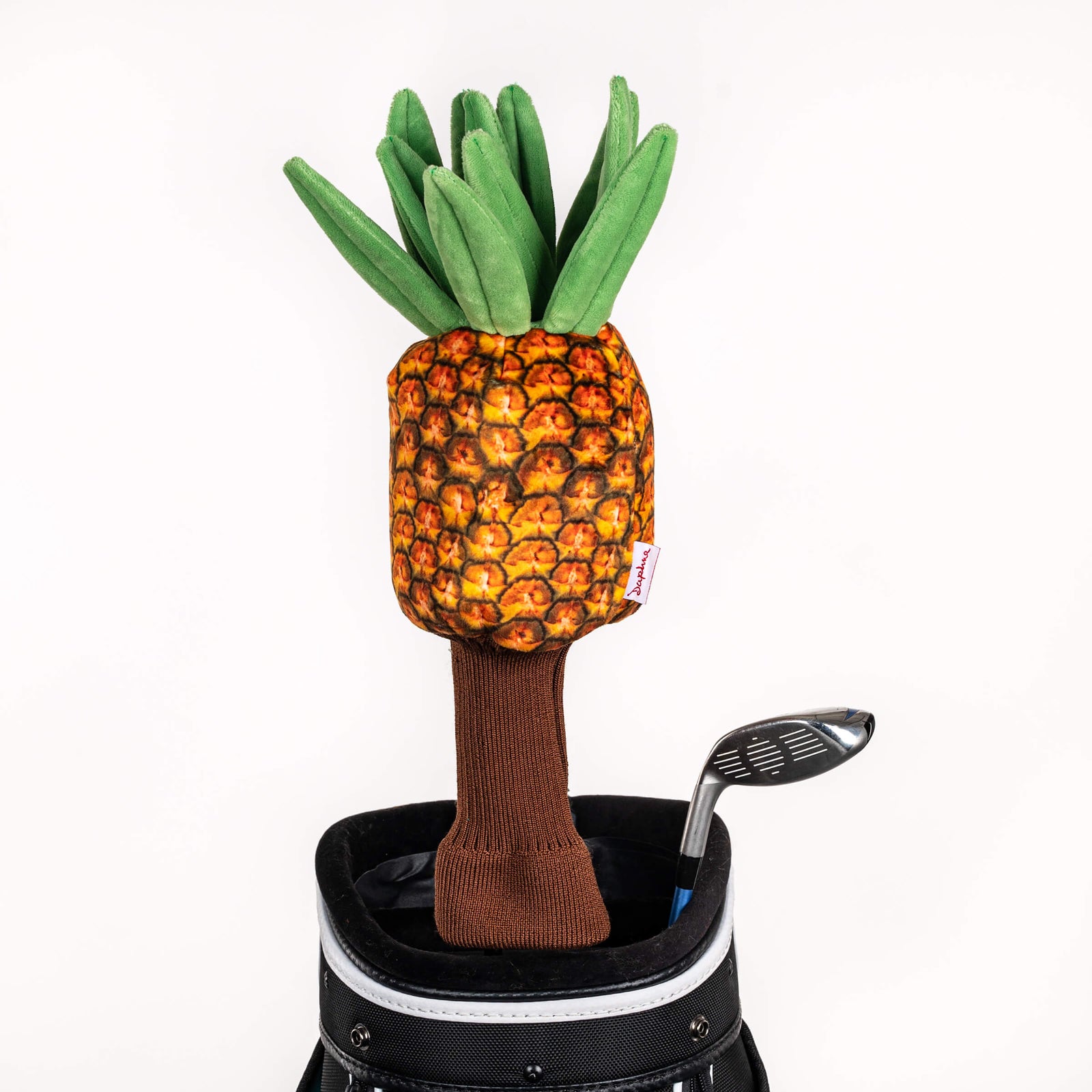 Plush pineapple golf headcover covering a club in a golf bag, a standout golf gift for men from Groovy Guy Gifts
