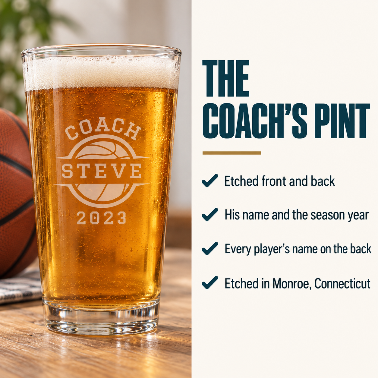 Pint glass filled with amber beer, engraved with basketball and sample personalization reading "COACH STEVE" with date "2023", sitting on wood surface with basketball nearby