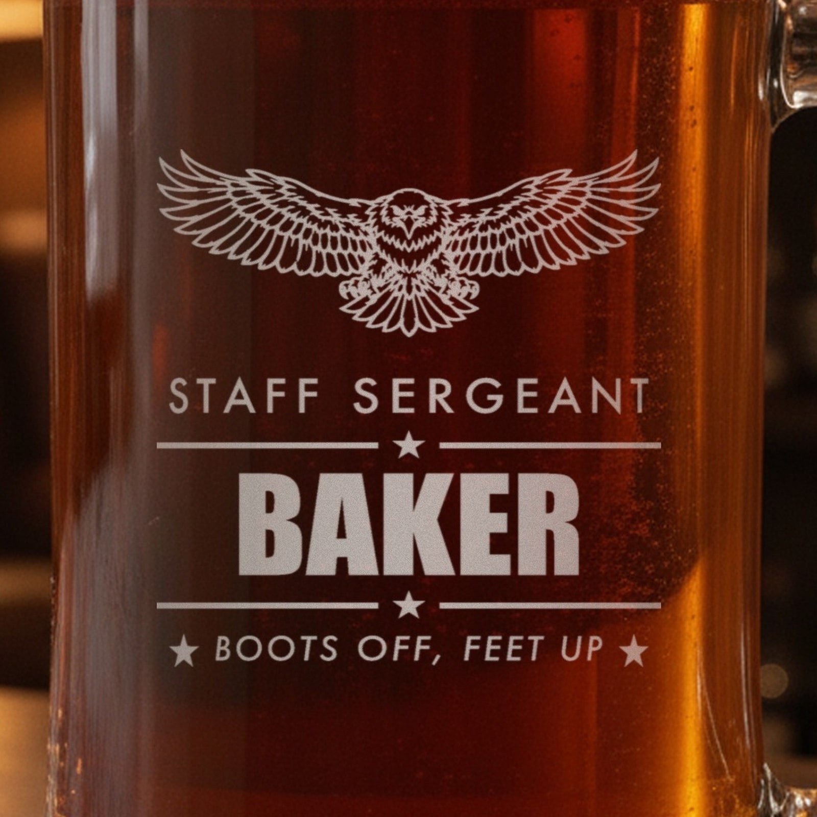 Close-up of the frosted eagle engraving on a retired Army gift stein: Staff Sergeant, Baker between star rules and Boots Off, Feet Up