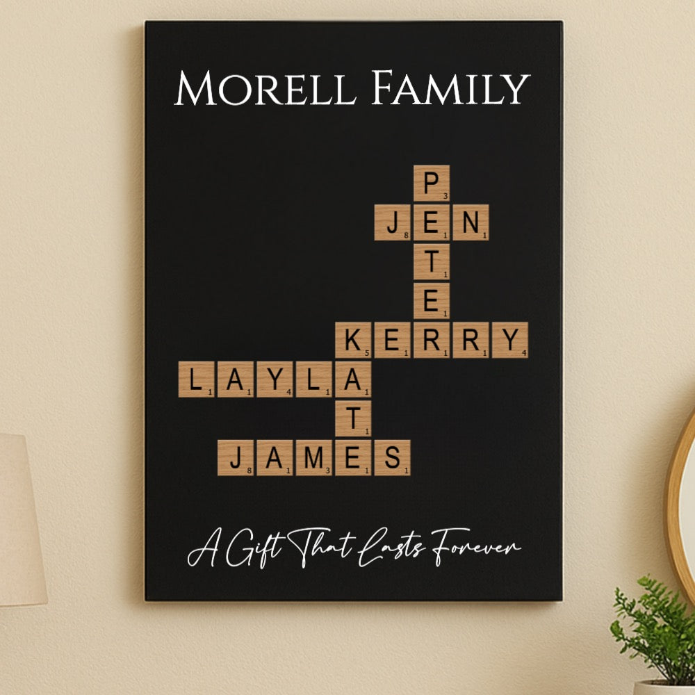Black wall sign displaying "MORELL FAMILY" at top with Scrabble-style tiles arranged in crossword pattern showing sample family names Jen, Kerry, Layla, James, and Pente, tagline below