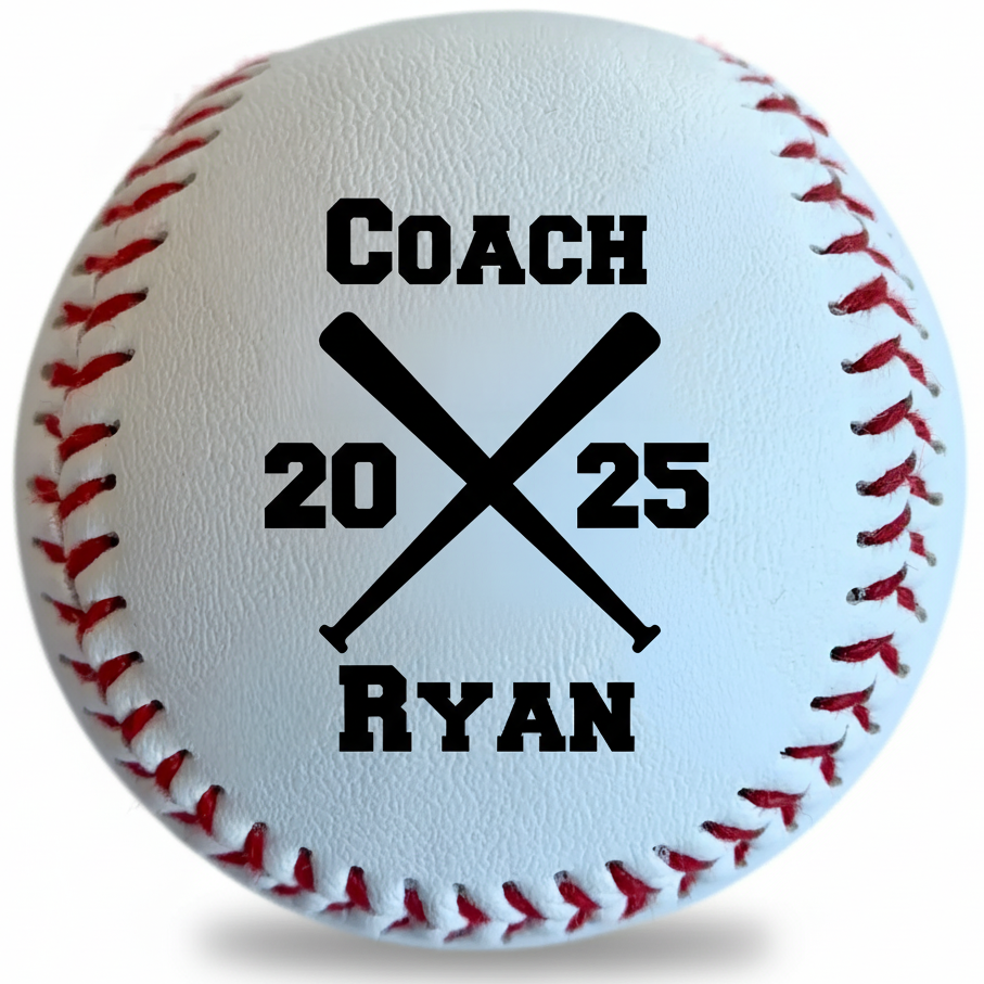 Engraved coach baseball with 'Coach 2025 Ryan' personalized in a crossed-bats design on white leather with red stitching.