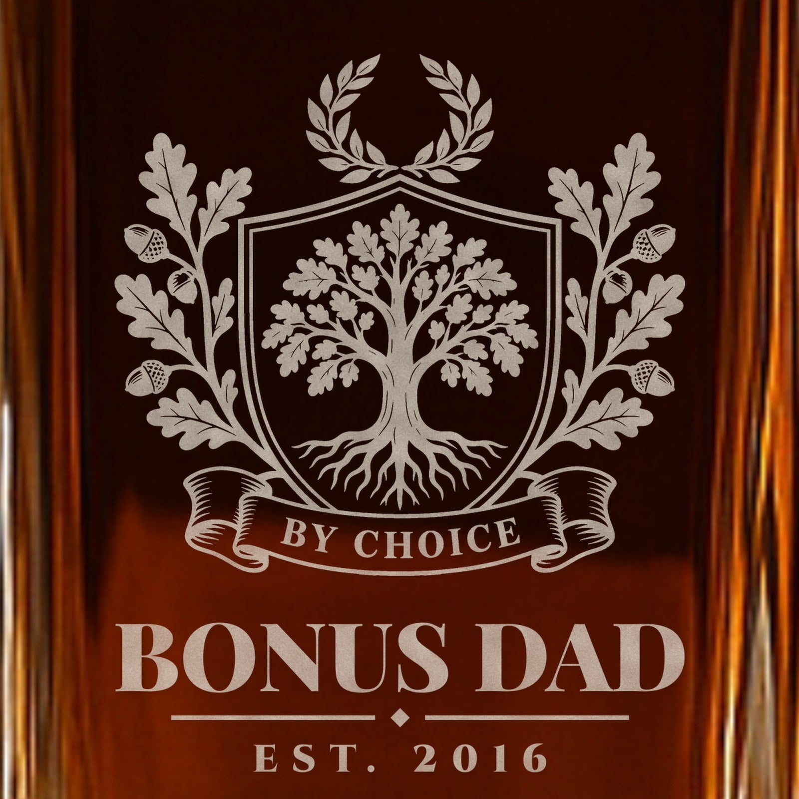 Close-up of the frosted By Choice crest on a bonus dad decanter: a rooted oak tree, oak branches, a laurel and the words Bonus Dad, Est. 2016