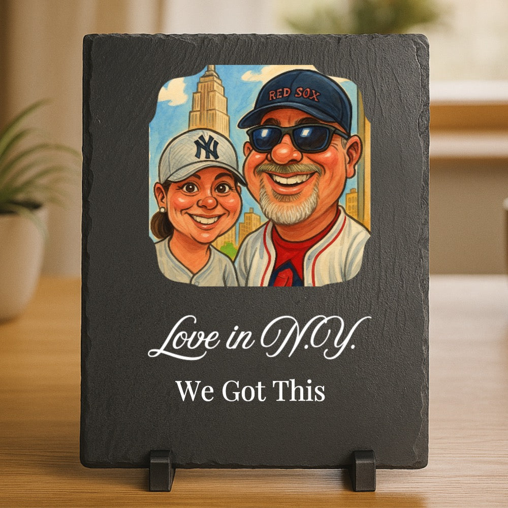 Black slate plaque featuring custom caricature of two people wearing baseball caps with New York Yankees and Red Sox logos, set against cityscape background, with text "Love in D.D.Y." and "We Got This" engraved below