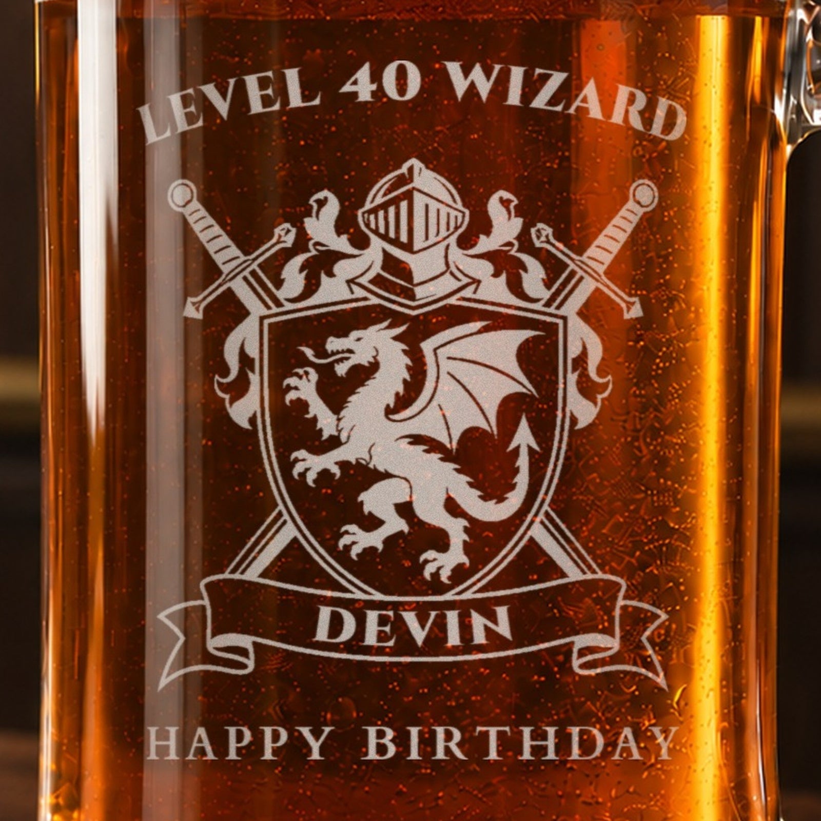 Close-up of the frosted dragon crest engraving on a gamer birthday beer mug reading LEVEL 40 WIZARD, DEVIN and HAPPY BIRTHDAY