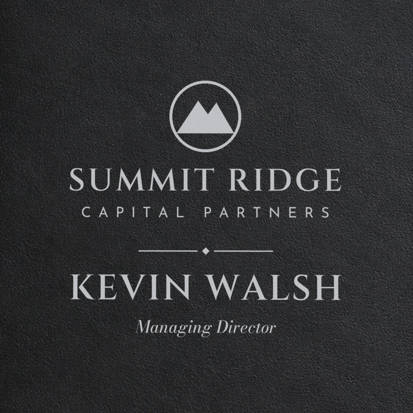 Close-up of the silver laser engraving on the black logo padfolio: a sample Summit Ridge logo, Kevin Walsh and Managing Director in italic