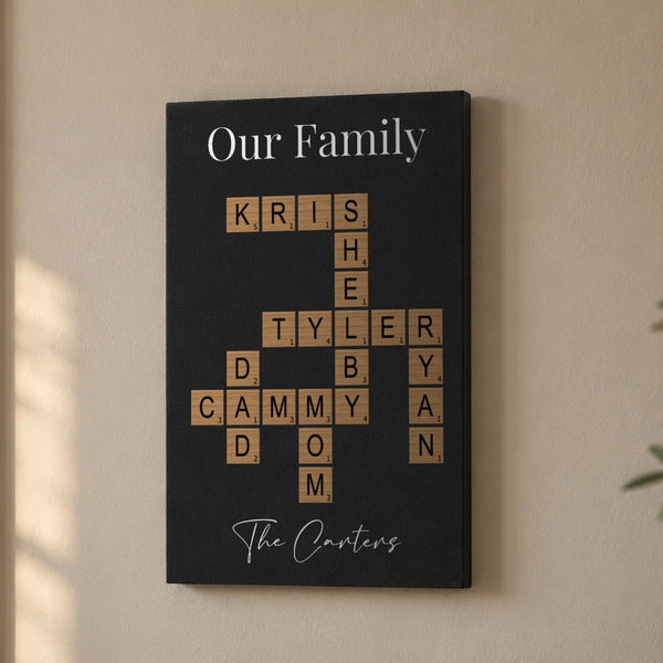 Family crossword wall art on a living room wall, Our Family title over wood-tone letter tiles spelling Kris, Shelby, Tyler, Ryan, Dad, Cammy and Mom