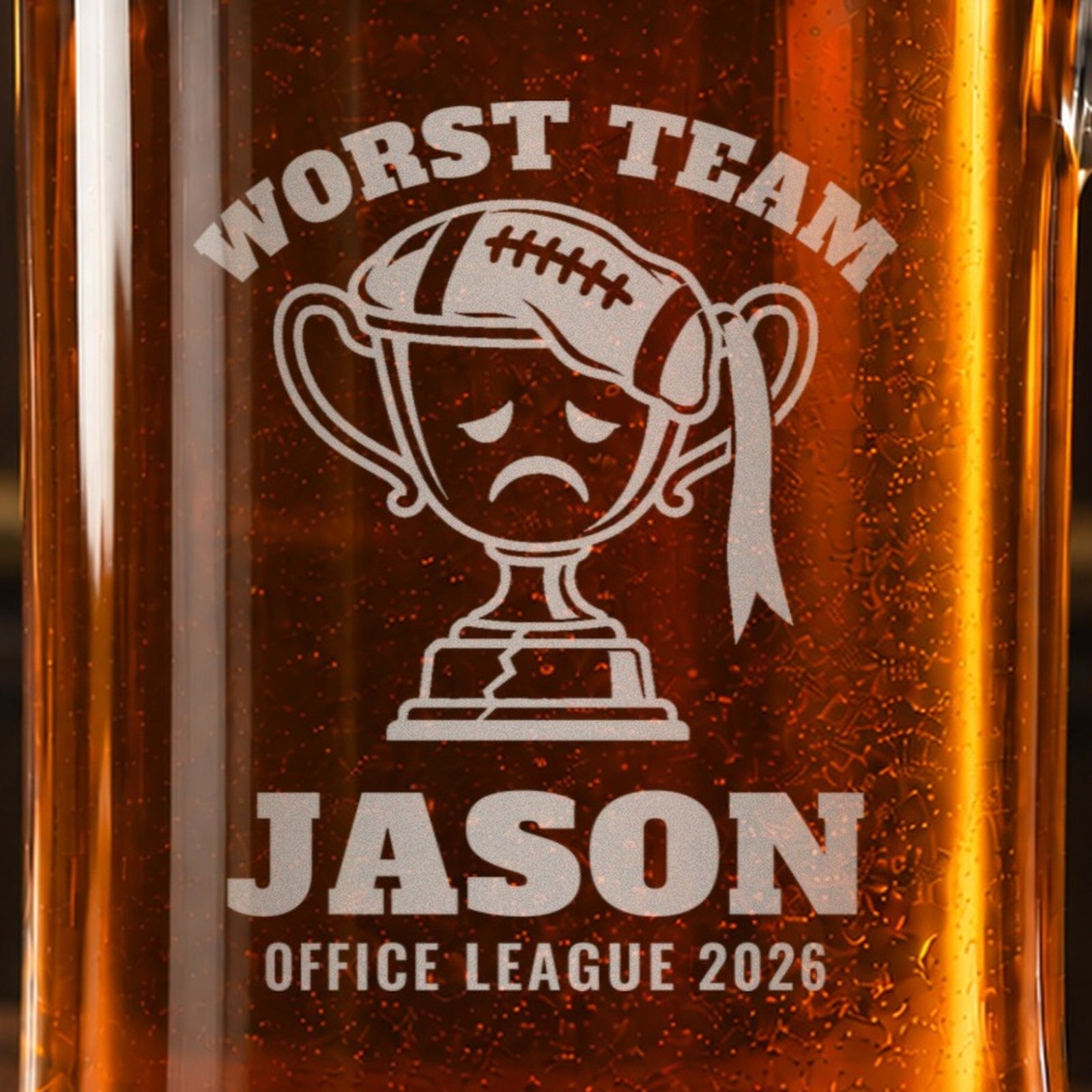 Close-up of the frosted last place trophy engraving on the stein: a sad trophy with a flat football, Worst Team, Jason and Office League 2026