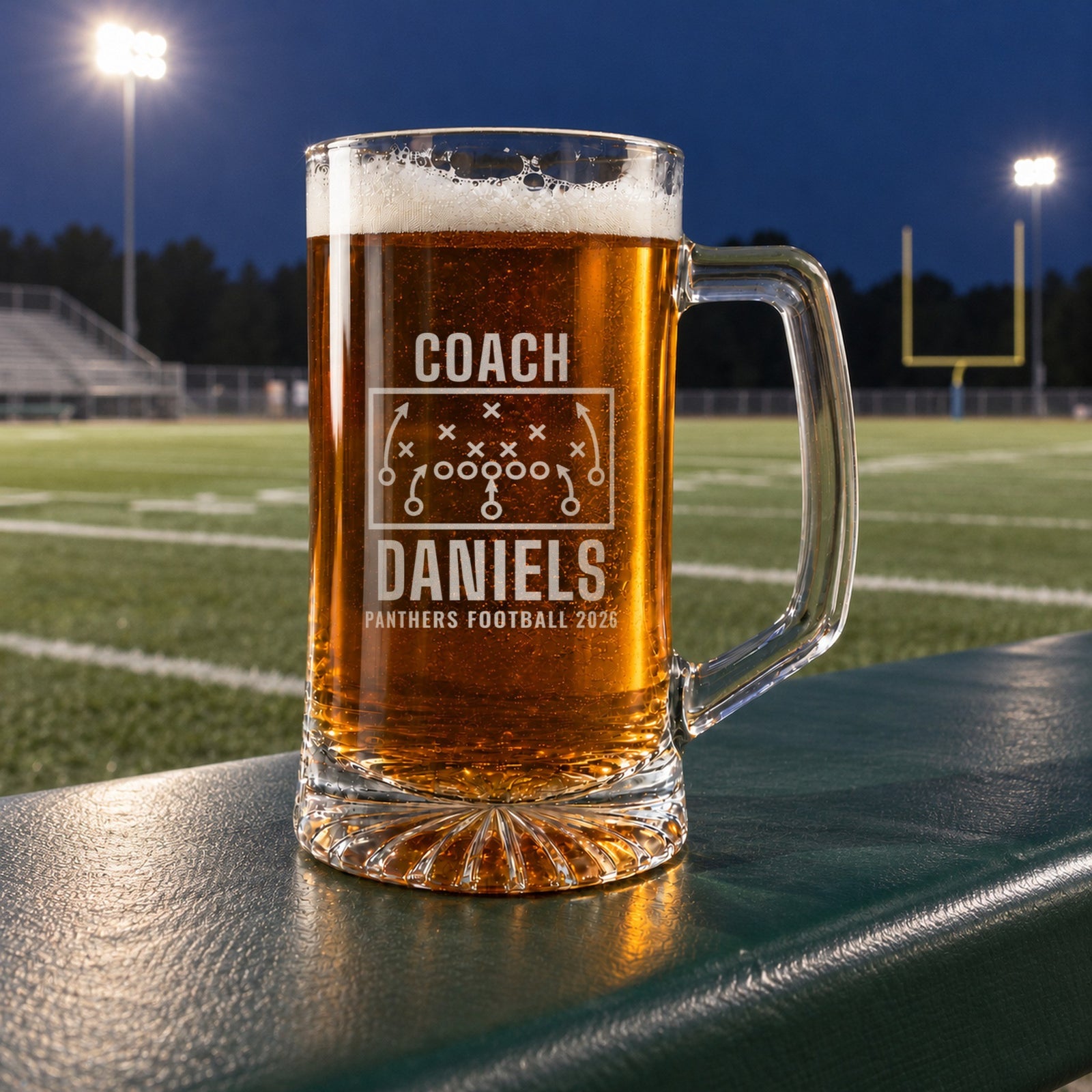 Personalized football coach playbook beer stein in a real setting, engraved with a football play diagram with X's, O's and routes: Coach, Daniels, Panthers Football 2026