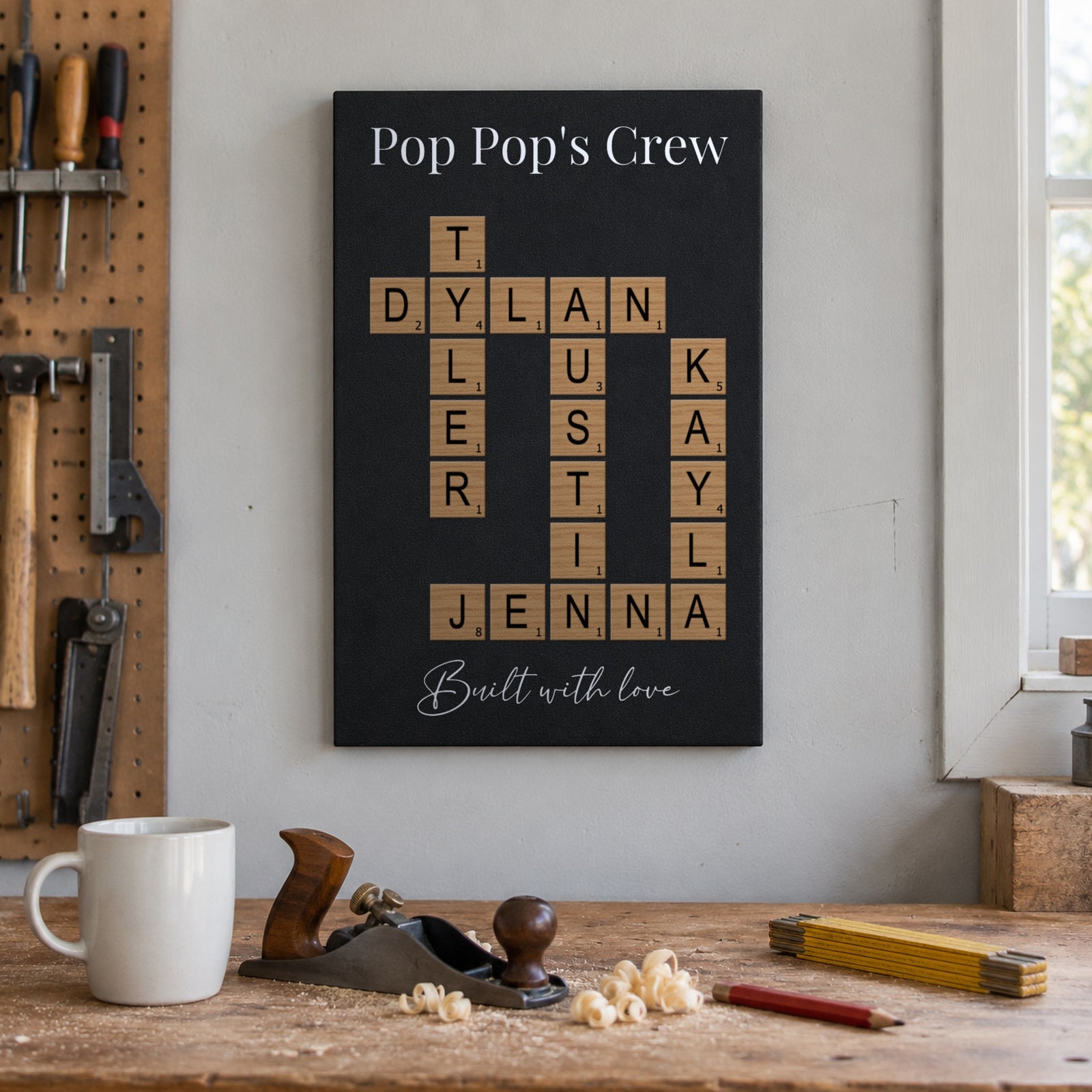 Gift for Grandpa from the grandkids: a Pop Pop's Crew crossword sign above a woodworking bench with a hand plane, mug and wood shavings