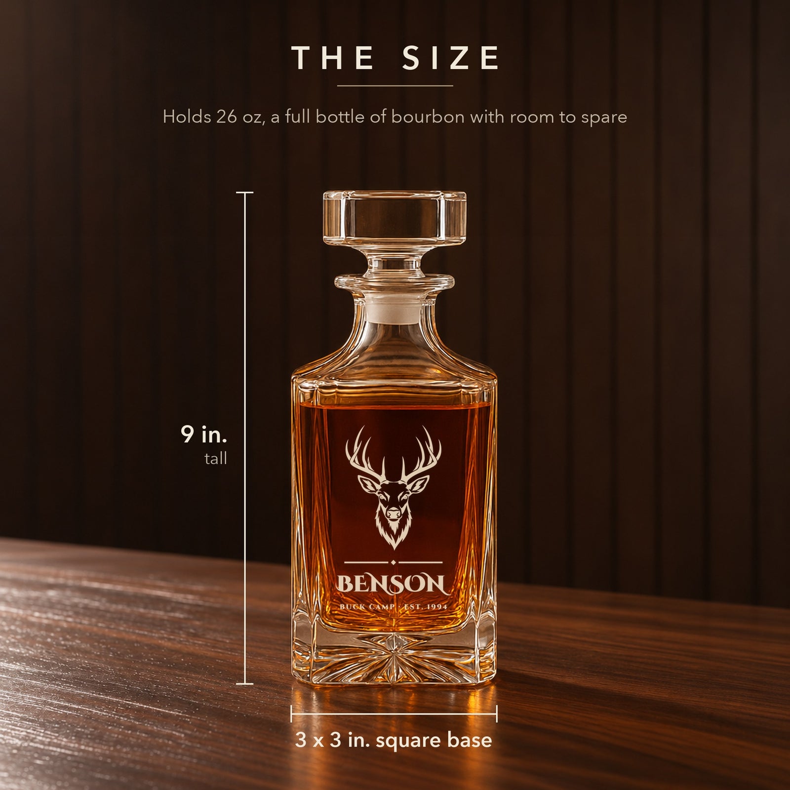 Size of the personalized hunting whiskey decanter on a walnut bar: 9 inches tall, 3 by 3 inch square base, holds 26 oz, a buck over Benson