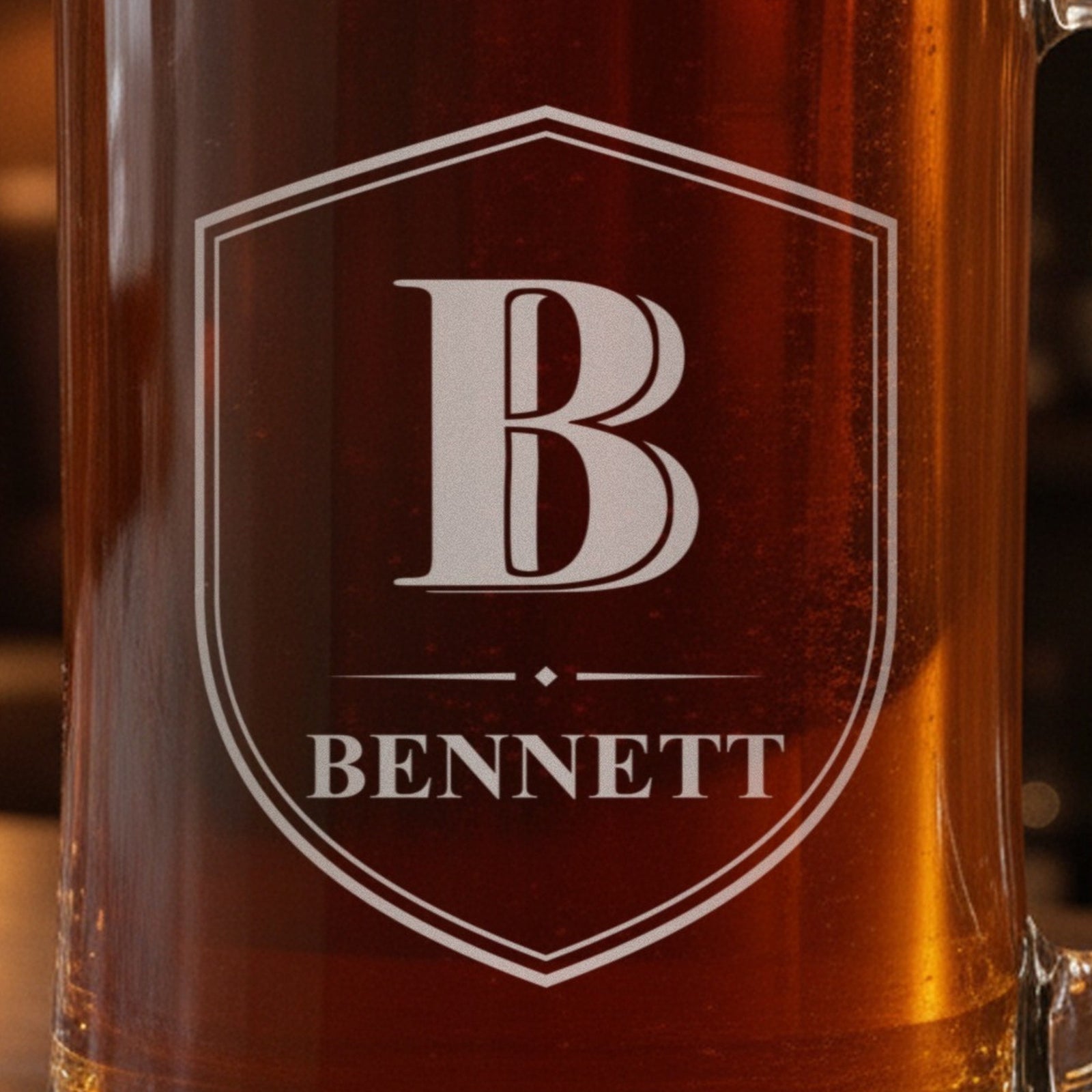 Close-up of the frosted laser engraving on the monogram beer stein, a Shield Crest with the initial B, a diamond divider and the name Bennett