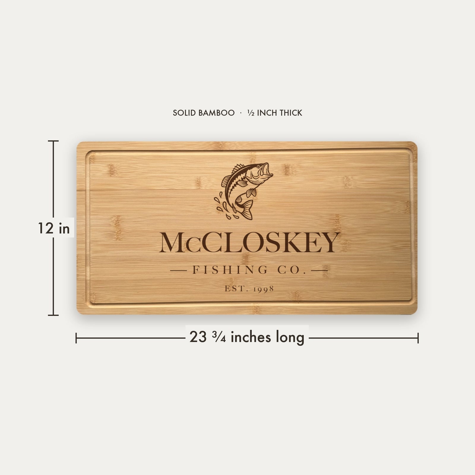 Size guide for the personalized fishing cutting board, 23 and three quarter inches long by 12 inches wide in half inch thick solid bamboo.