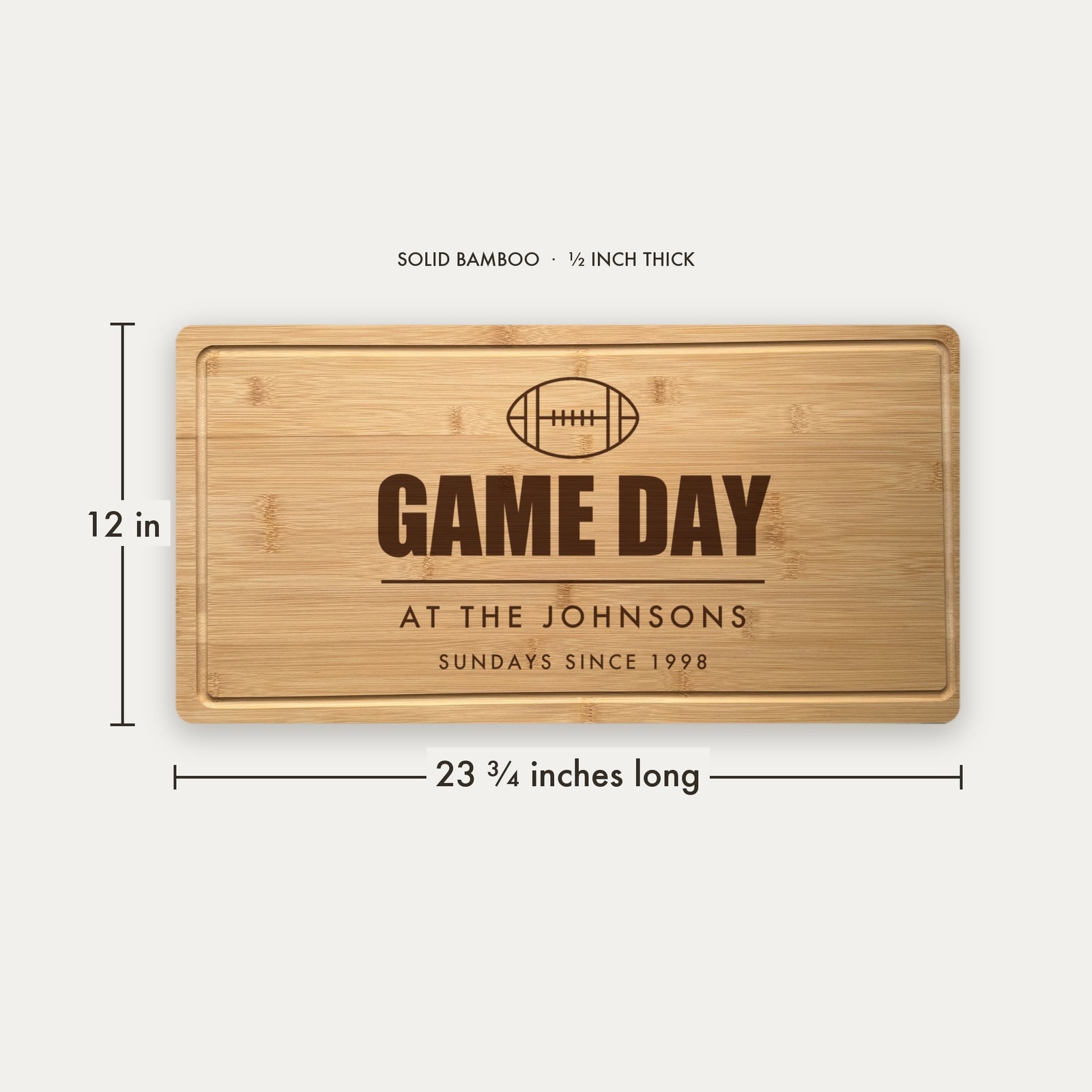 Size guide for the personalized game day cutting board, 23 and three quarter inches long by 12 inches wide in half inch thick solid bamboo.