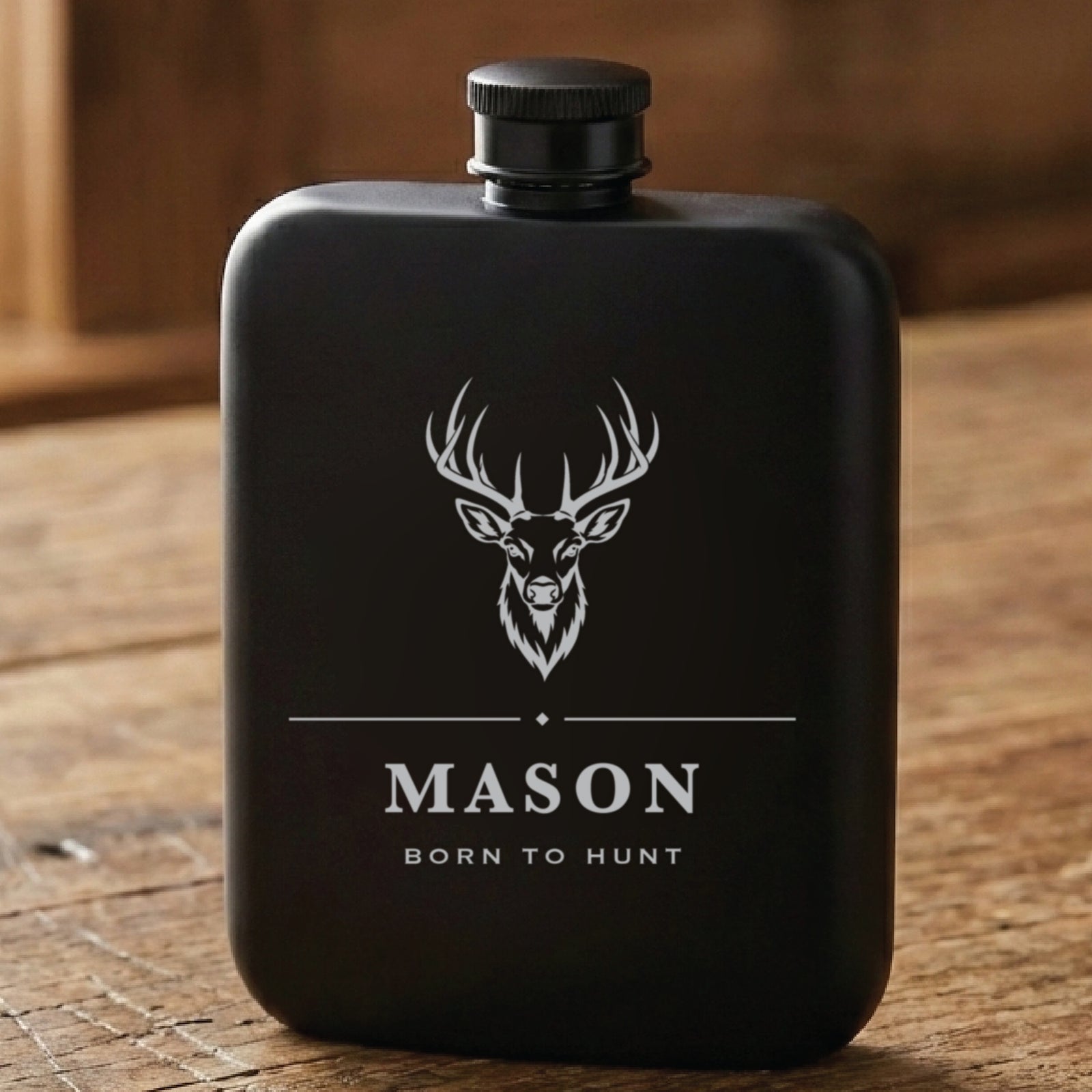 Matte black personalized hunting flask laser engraved with a whitetail buck above the name Mason and the line Born to Hunt.