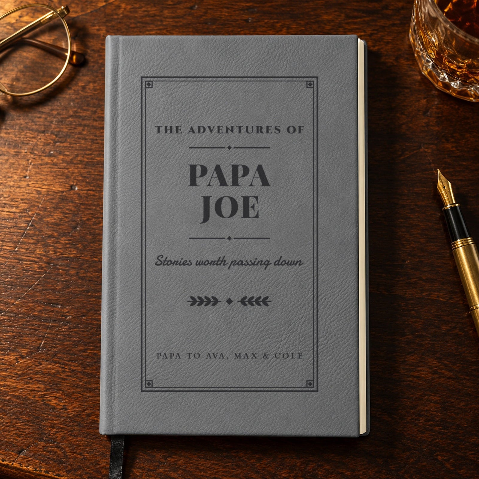 Personalized grandpa journal in gray engraved The Adventures of Papa Joe and Papa to Ava, Max & Cole, on a walnut desk, a Christmas gift for grandpa
