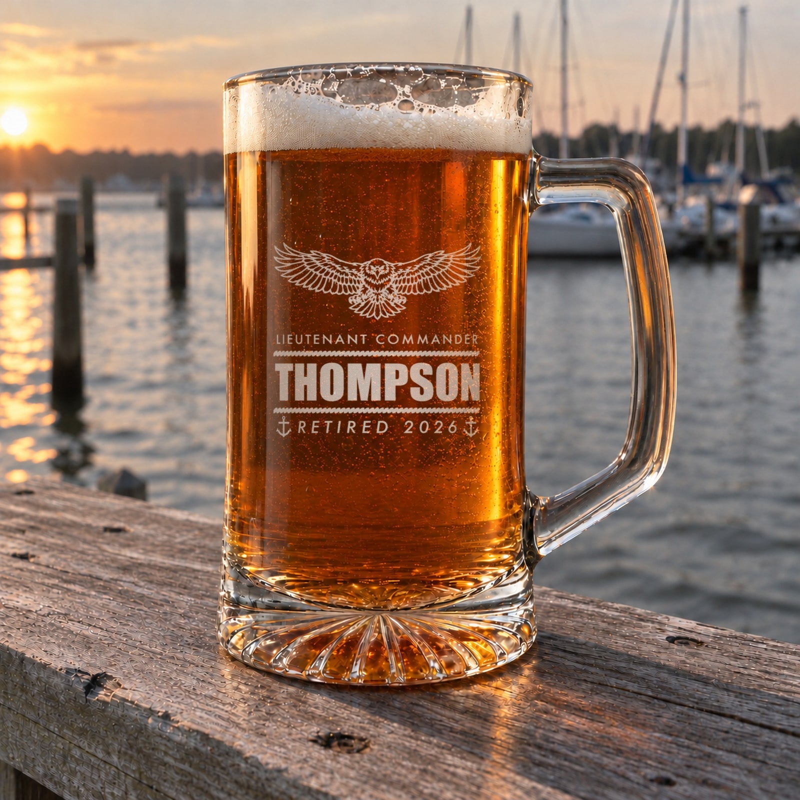 Personalized Navy retirement beer stein on a weathered dock rail at a marina at sunset, engraved Lieutenant Commander, Thompson, Retired 2026