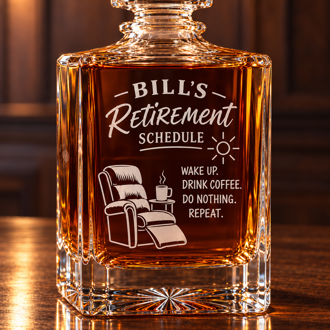 Close-up of the frosted engraving on a funny retirement decanter reading BILL'S Retirement Schedule: wake up, drink coffee, do nothing, repeat