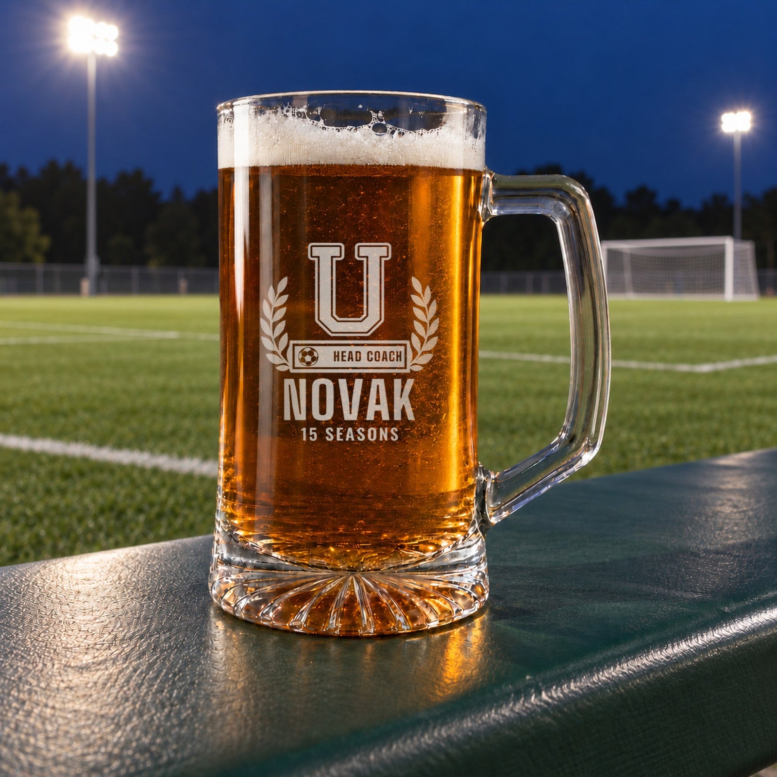 Personalized soccer coach letterman beer stein in a real setting, engraved with a varsity letter with laurel and a soccer ball COACH bar: U, Head Coach, Novak, 15 Seasons