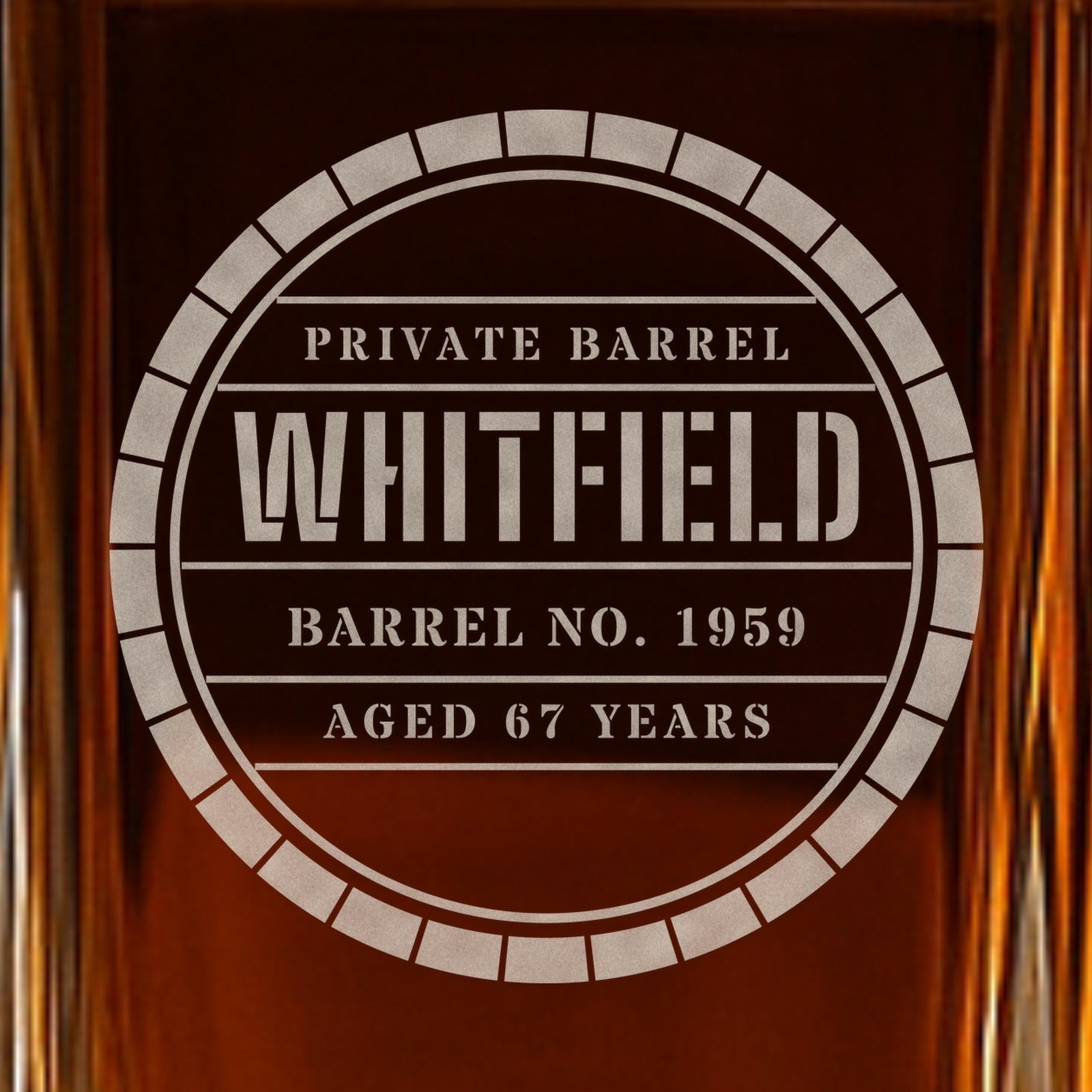 Close-up of the frosted barrel head engraving on a whiskey decanter: Private Barrel, Whitfield, Barrel No. 1959, Aged 67 Years, in stencil letters