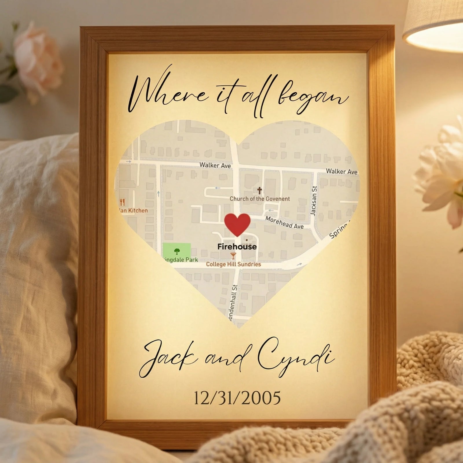 Framed map light featuring heart-shaped design with sample personalization "Where it all began Jack and Cyndi 12/31/2005" and red heart marking "Firehouse" location