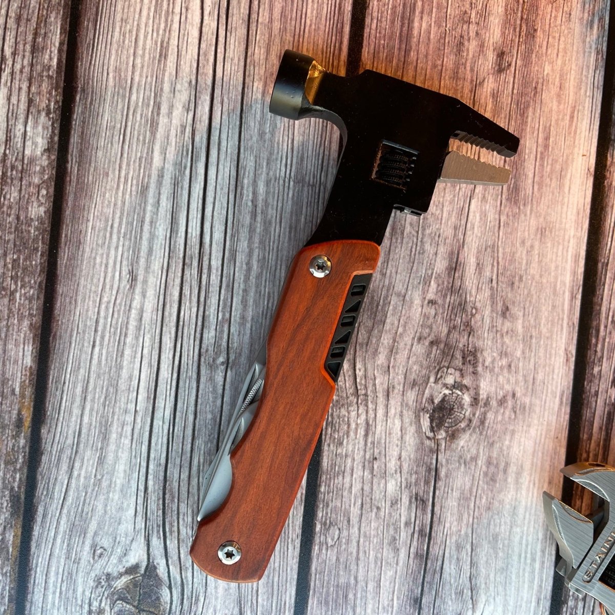 Closed multi tool against wood background