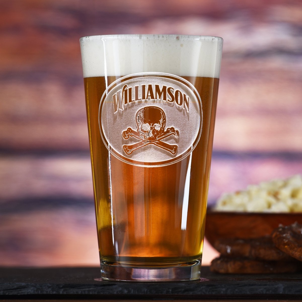 Crossbones personalized pub pint glass with sand-carved skull and bones design