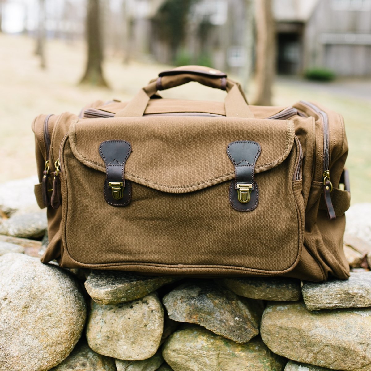 Durable brown canvas duffle bag with leather trim and multiple compartments for travel or gym