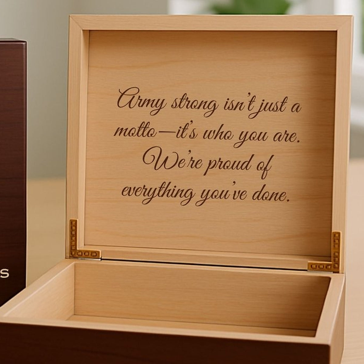 Spanish cedar lid of the military keepsake gift box engraved with a personal message above the open wooden box.