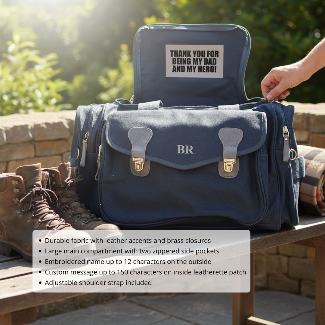 Navy duffle bag with monogrammed initials "BR" and sample custom message "THANK YOU FOR BEING MY DAD AND MY HERO!" displayed on interior leather patch, shown open with adjustable strap visible
