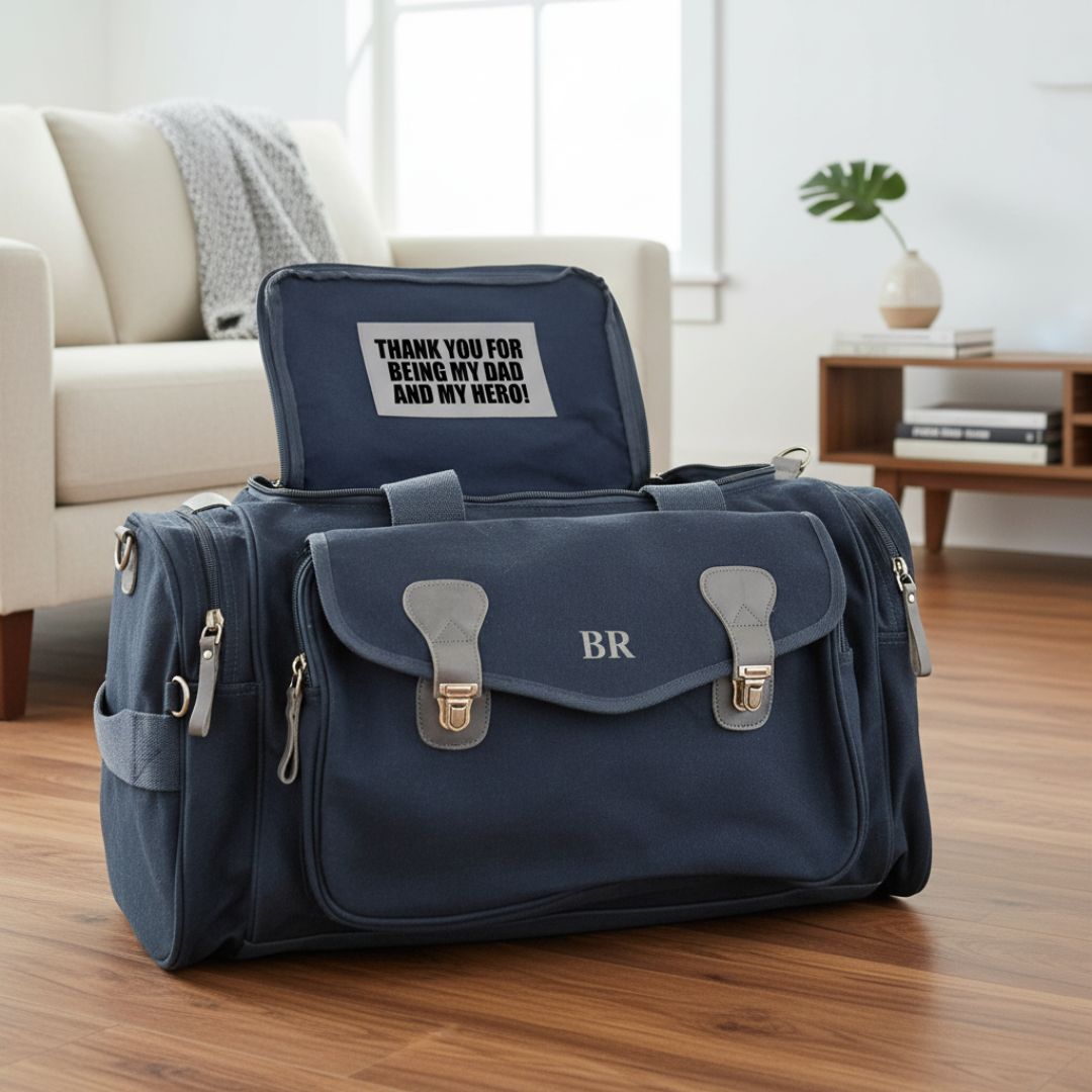 Navy duffle bag with monogrammed initials "BR" on front flap, displayed open with sample personalization "THANK YOU FOR BEING MY DAD AND MY HERO!" visible on interior lid