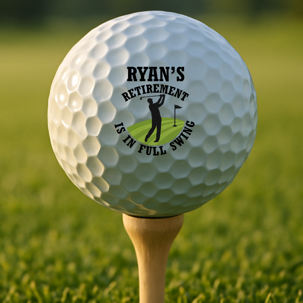 Custom-engraved retirement golf balls on green with golfer silhouette