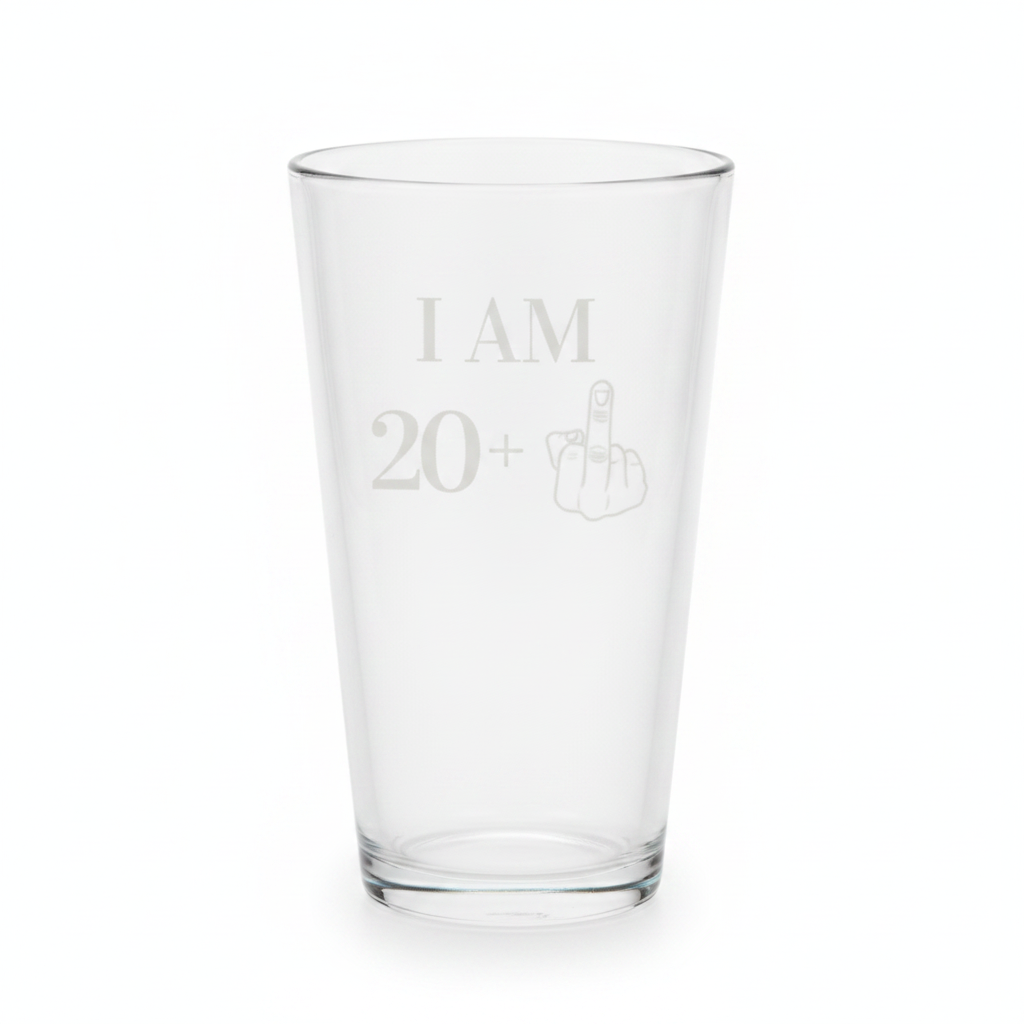 Clear pint glass engraved with a bold I AM 20+ message and middle-finger graphic, a funny 21st birthday beer glass gift for the new legal drinker.