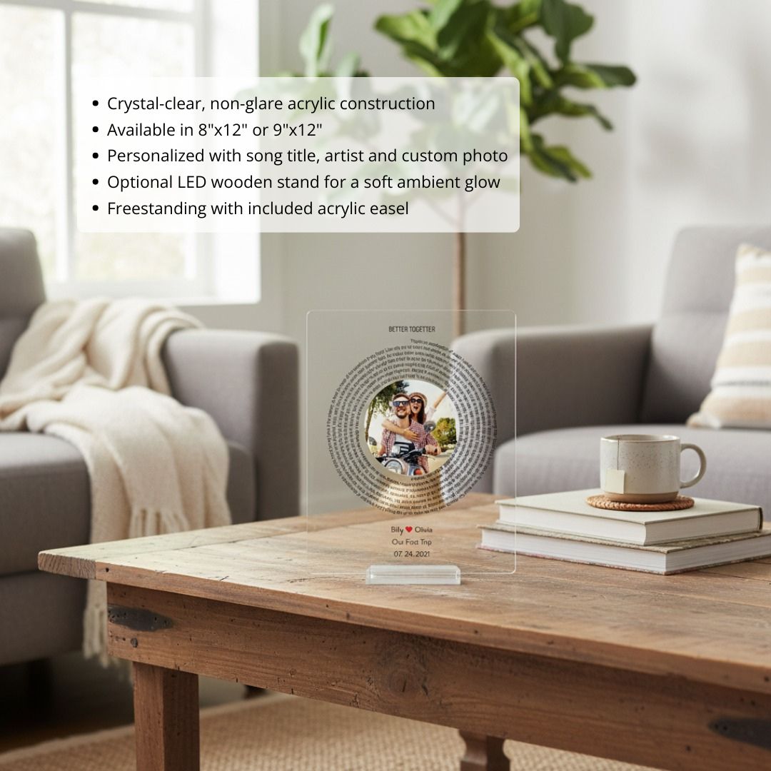 Personalized acrylic plaque displayed on wooden table, featuring sample photo of couple in circular center with "BETTER TOGETHER" text and song lyrics spiraling around border, engraved with names "Billy ♥ Olivia" and date "07.24.2021